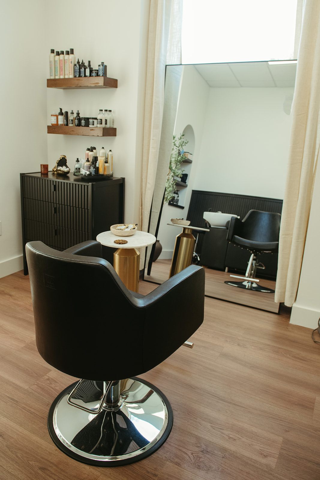 The styling chair and mirror inside the Mane Haven private suite